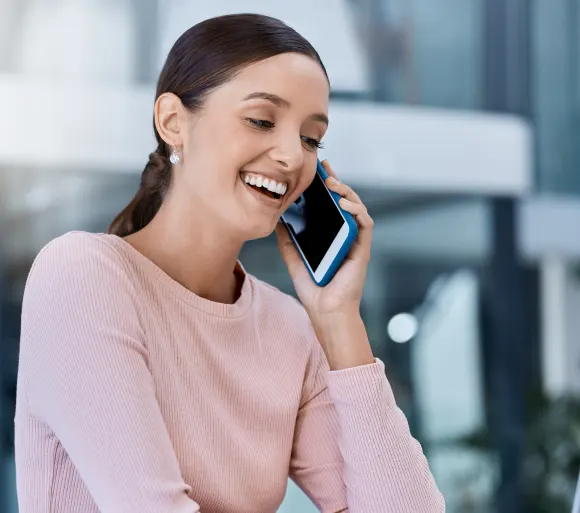 A smiling client taking a phone call to book a cleaning