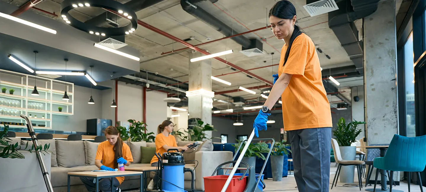 A Choice Cleaning Plus crew cleaning a modern open-plan office
