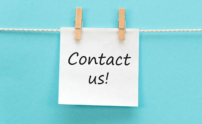 A note reading Contact us pinned to a line