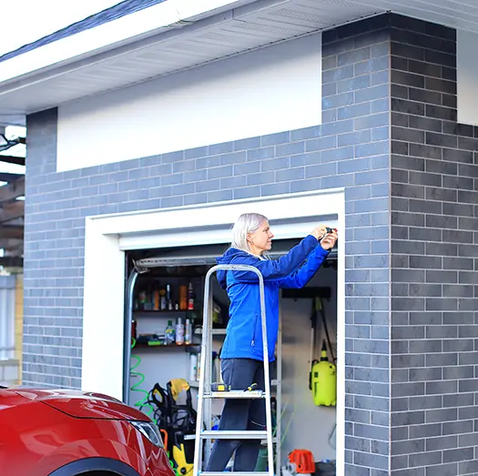 A spacious, freshly cleaned garage interior with brick walls and concrete floor