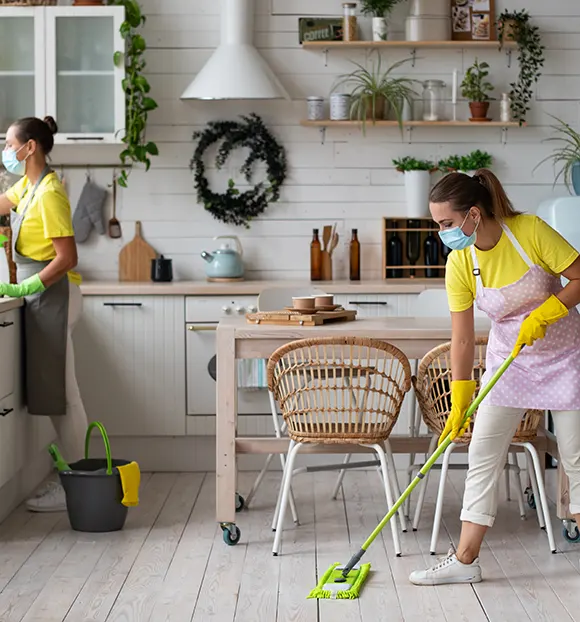 A cleaner detailing a kitchen after construction